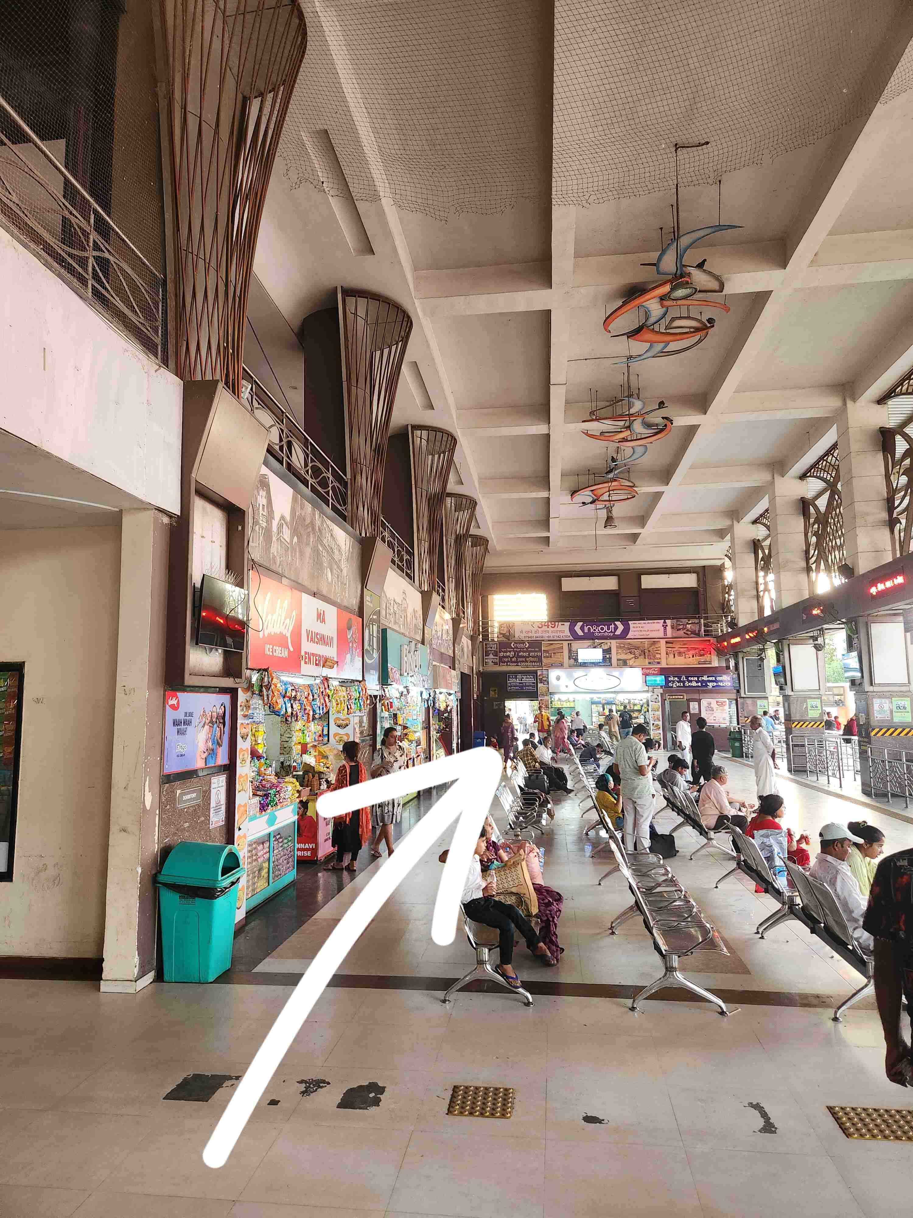 Bus depot waiting area with seating and direction to lift